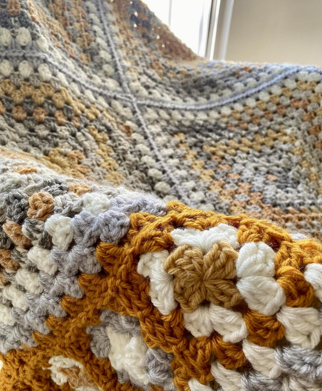 Gorgeous detail of beautiful premium King Cole Drifter yarn in the Winter Berry crochet blanket